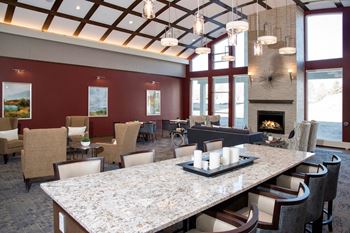 Resident lounge with kitchen, dining space and fireplace